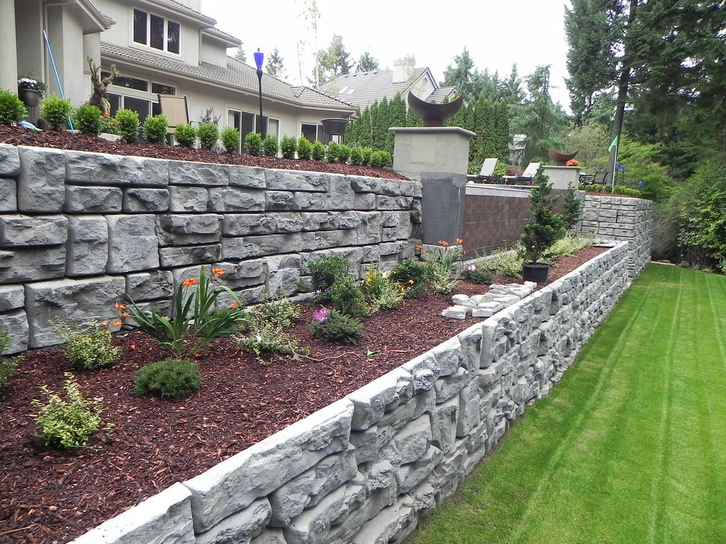 Stone retaining wall and landscaped bed